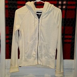 Really soft, off white, zip-up hooded jacket.